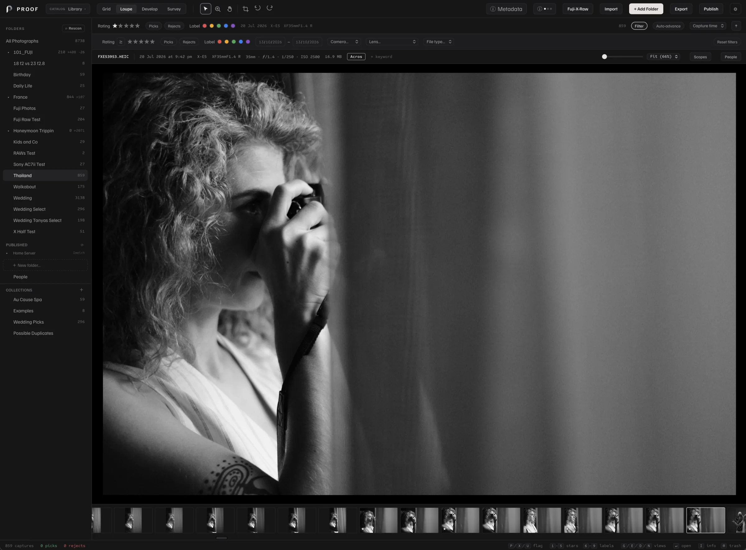 A black-and-white photograph of a person holding a camera, open in Proof’s Loupe workspace